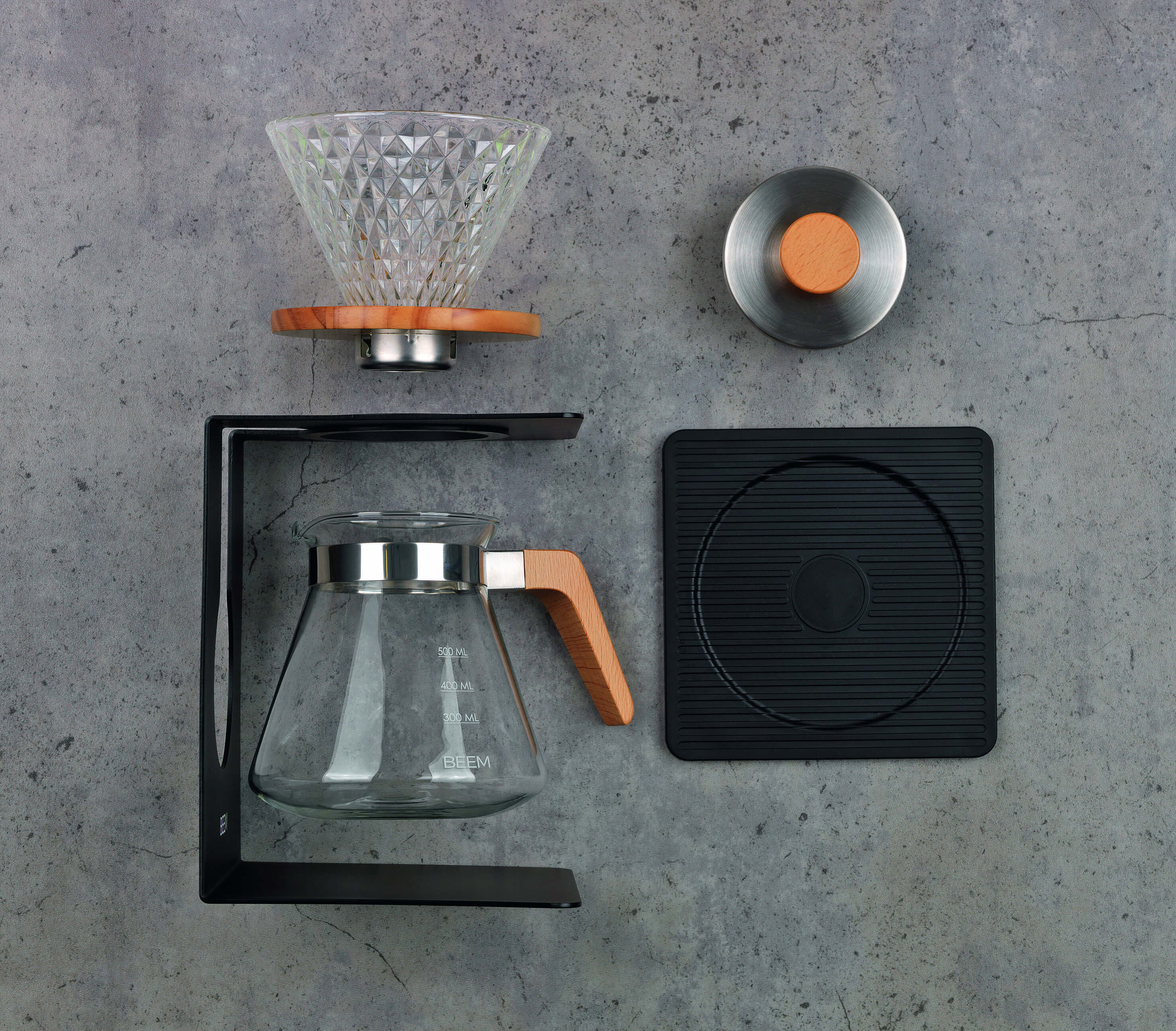 Beem Pour Over Set mit Glaskanne und Filter vor Beton-Hintergrund Beem Pour Over Set mit Glaskanne und Filter vor Beton-Hintergrund